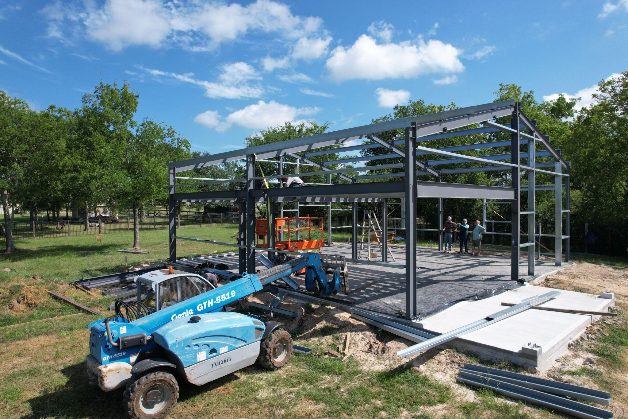 Pre-engineered steel frame of a detached shop under construction by Muleshoe Buildings in the Brazos Valley, TX