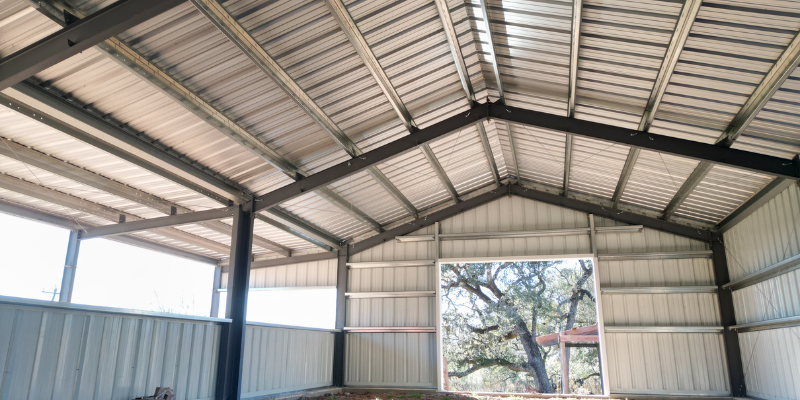 Interior view of a 30x60 agricultural storage barn showing rigid frame steel construction and open-span layout
