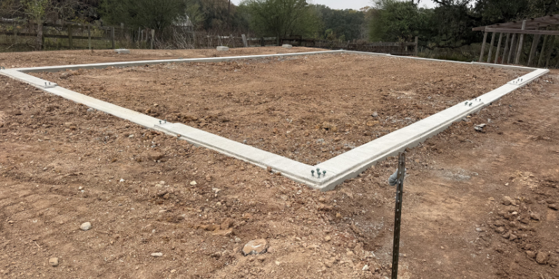 metal building site visit showing foundation layout and site preparation before construction