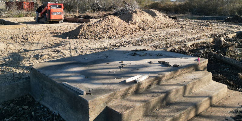 metal building pad with elevation change showing poor site preparation and increased fill requirements