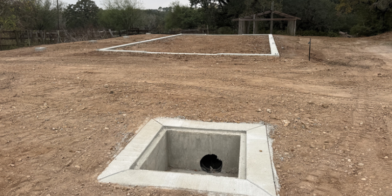 metal building site visit evaluating drainage and pad layout before construction