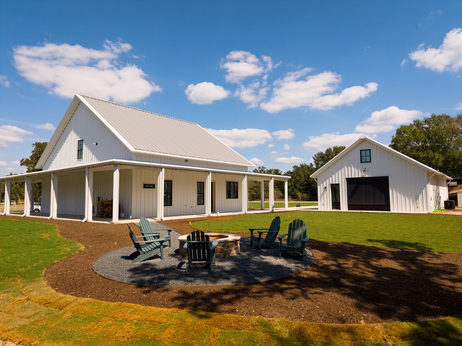 anderson-tx-barndominium-wraparound-porch-fire-pit-shop