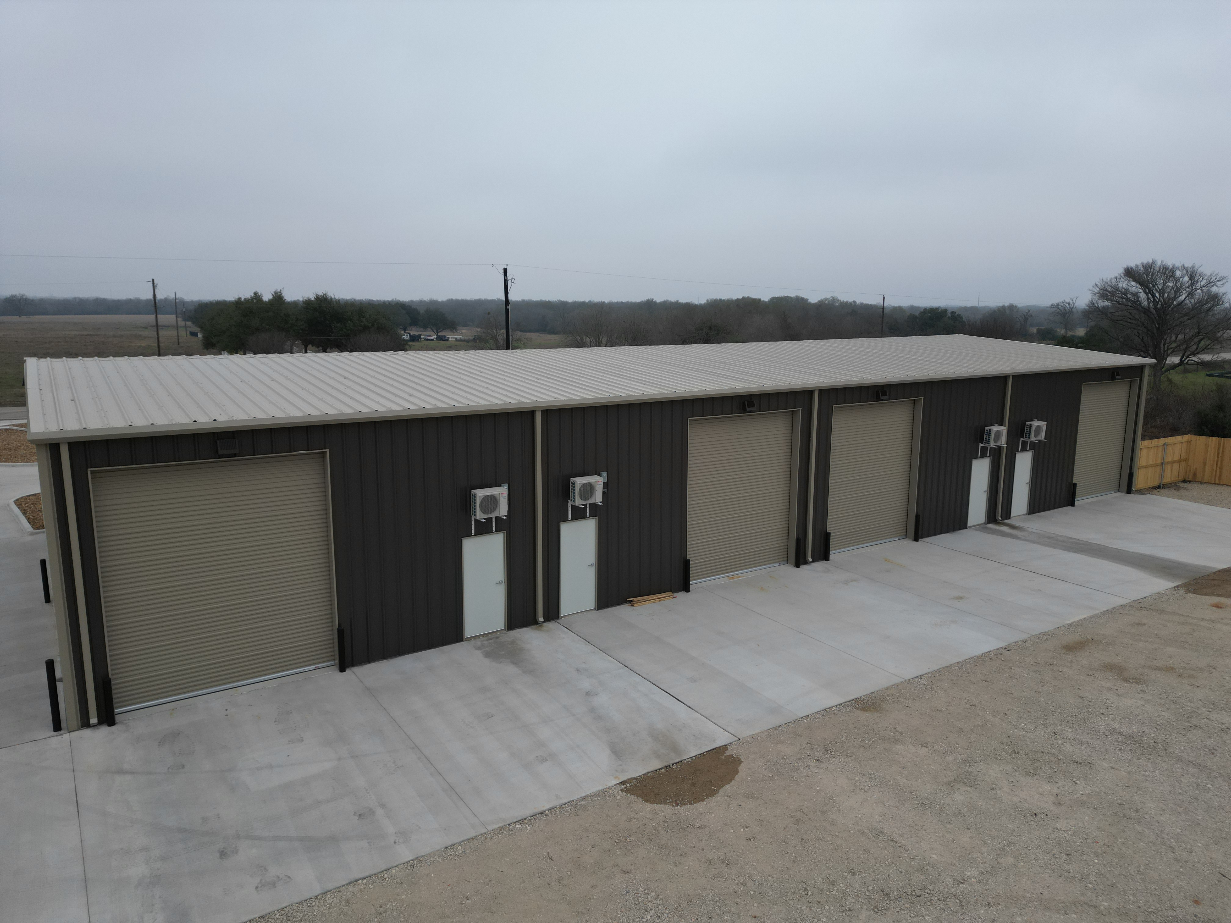 side view of commercial metal building showing divided layout and multiple entry points in Bryan Texas