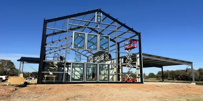 Pre-galvanized steel purlins and girts supporting roof and wall panels in a metal building framing system.