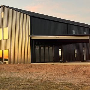 black-modern-barndominium-sunset-rural-texas