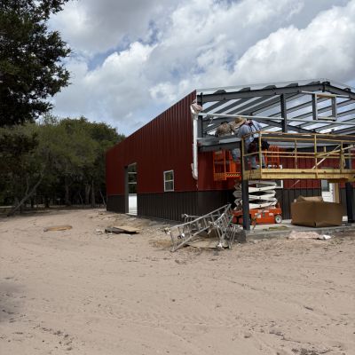 metal-building-crew-installing-wall-panels-and-trim