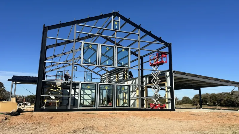 Pre-galvanized steel purlins and girts supporting roof and wall panels in a metal building framing system.