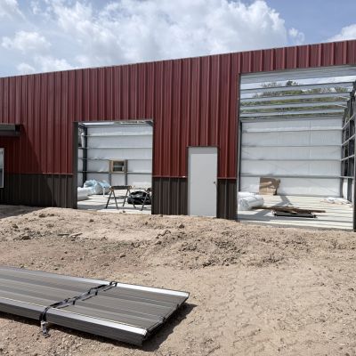red-and-black-barndominium-with-large-framed-openings