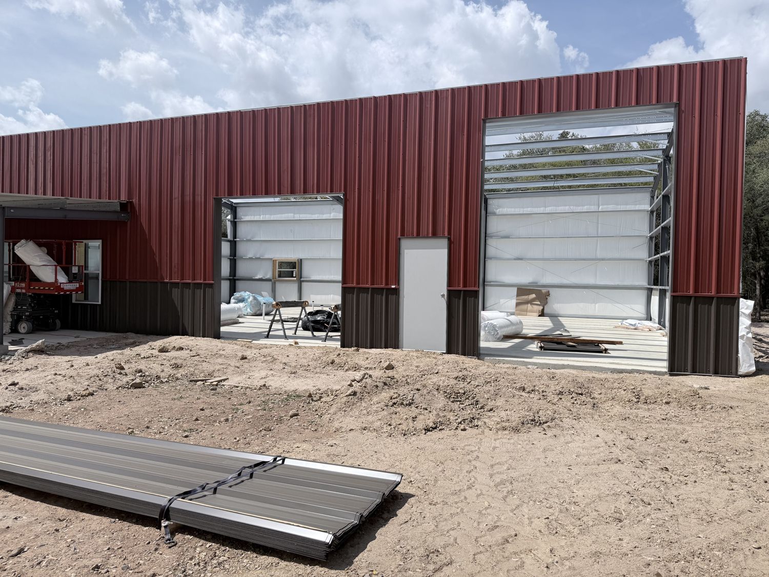 red-and-black-barndominium-with-large-framed-openings