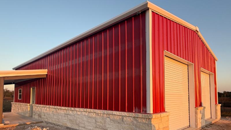 finished pre-engineered metal building shop in Texas with roll-up doors and covered entry