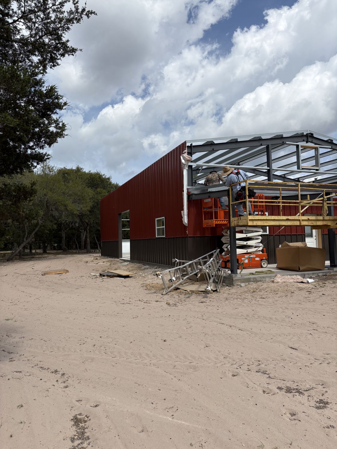 metal-building-crew-installing-wall-panels-and-trim