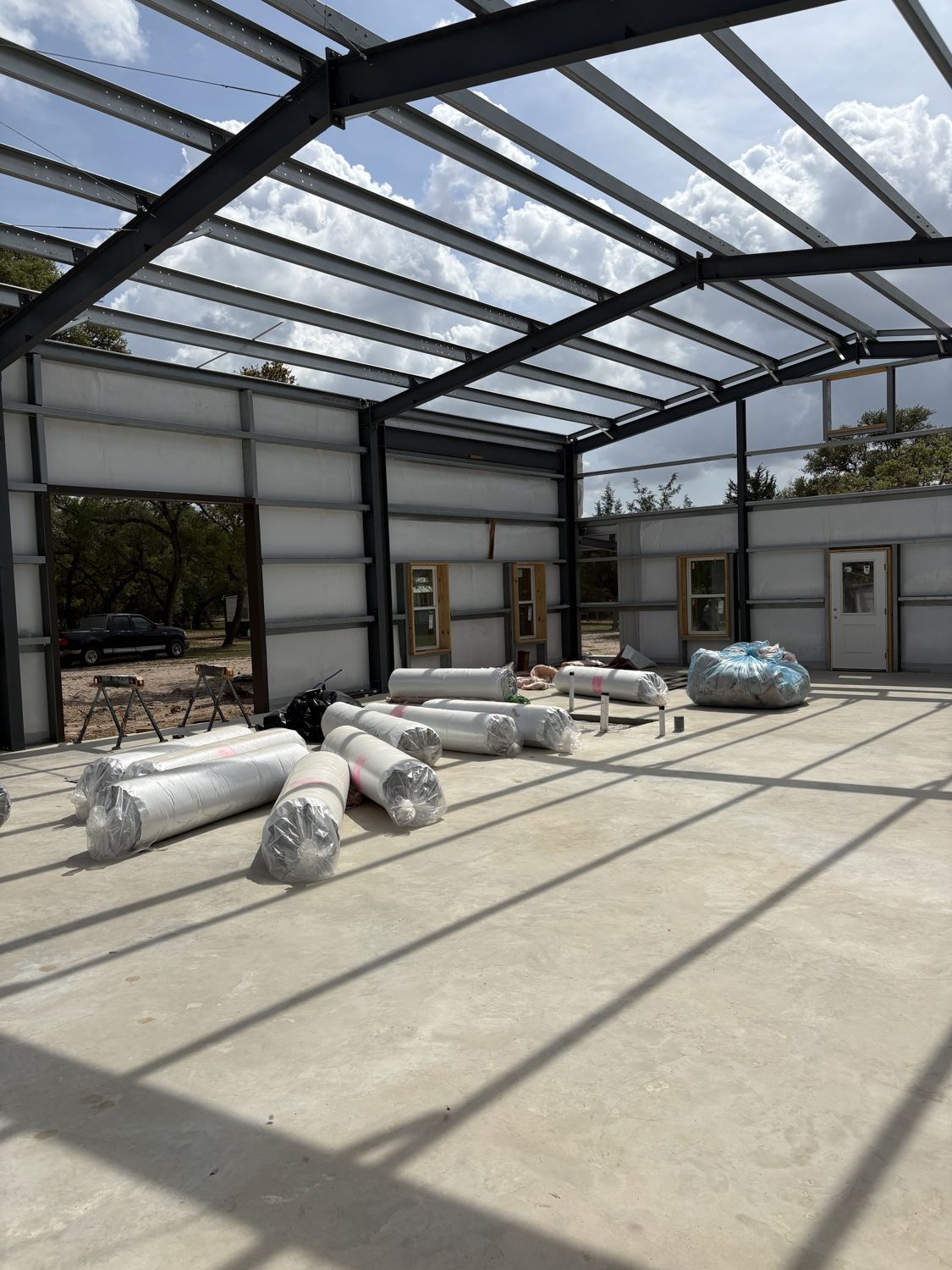 insulated-metal-building-interior-with-shop-door-opening